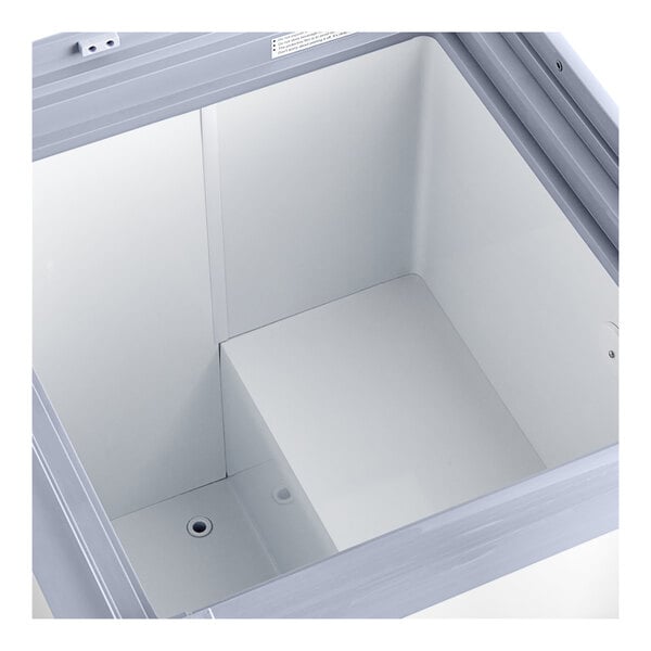 An Avantco ice cream dipping cabinet with a flat sneeze guard inside.