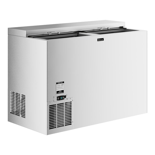 A stainless steel Perlick bottle cooler with a door open.