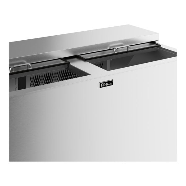 A stainless steel Perlick bottle cooler with two doors open.