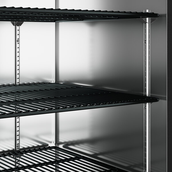 A black metal shelf inside a Perlick back bar refrigerator.