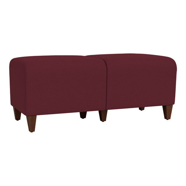 A red Lesro Ravenna bench with walnut wood legs.