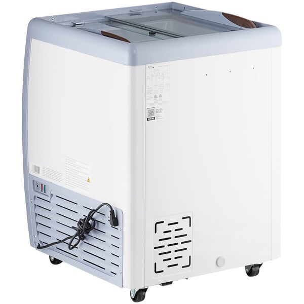 An Avantco white rectangular ice cream dipping cabinet with a glass top and wheels.