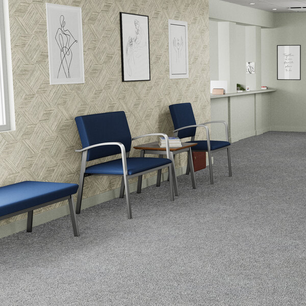 A blue vinyl guest arm chair with silver powder-coated steel legs, designed for waiting areas.