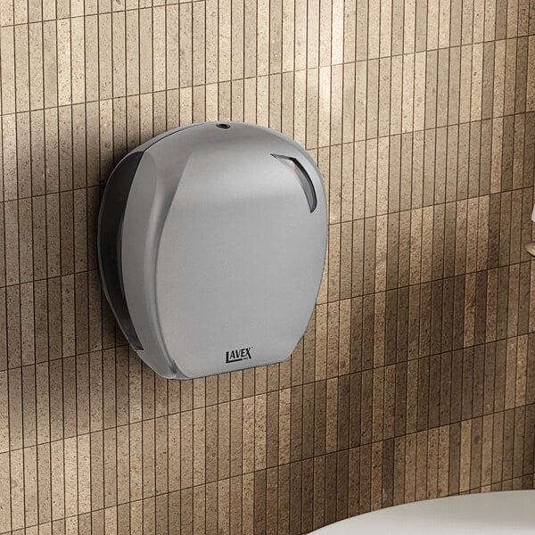 A Lavex Pro titanium commercial toilet paper dispenser on a white wall.