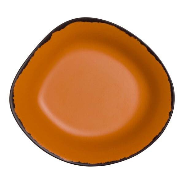 A clay colored melamine pasta bowl with a black rim and orange interior.