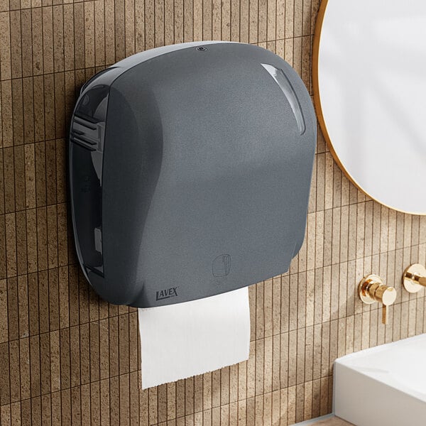 A Lavex Pro stone automatic paper towel dispenser on a tile wall.