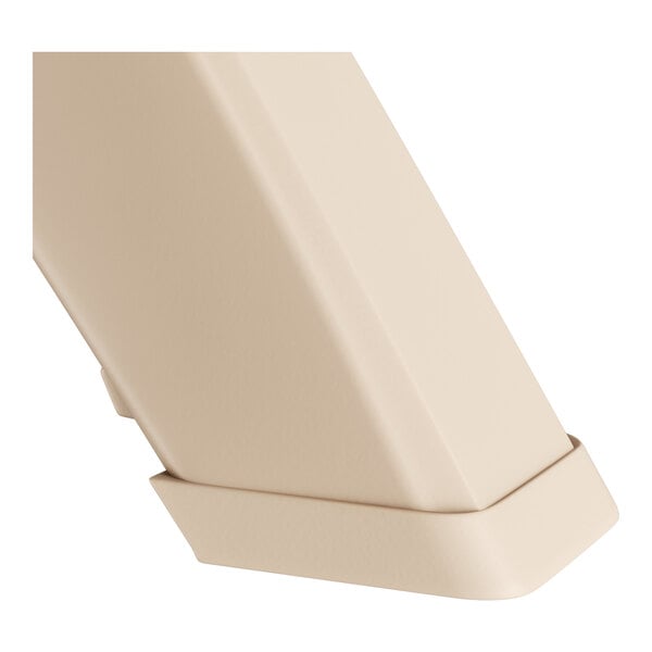 A close-up of a sandstone Grosfillex Ibiza table pedestal.