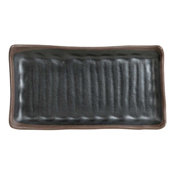 A black rectangular plate with a brown edge.