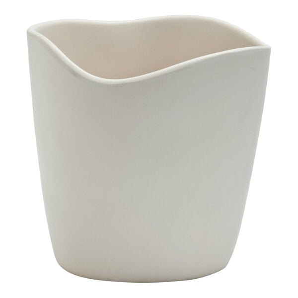 A white melamine mini dressing crock with a curved edge.