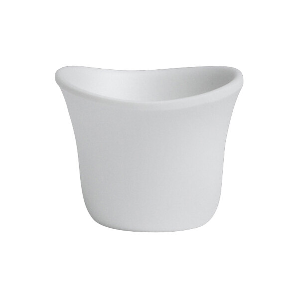 A Delfin white melamine sauce cup with a curved edge.