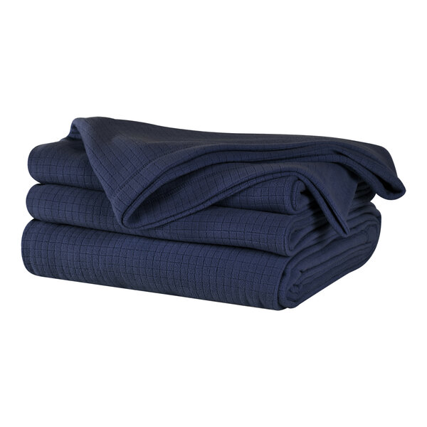 A stack of folded navy blue Berkshire Hospitality fleece blankets.