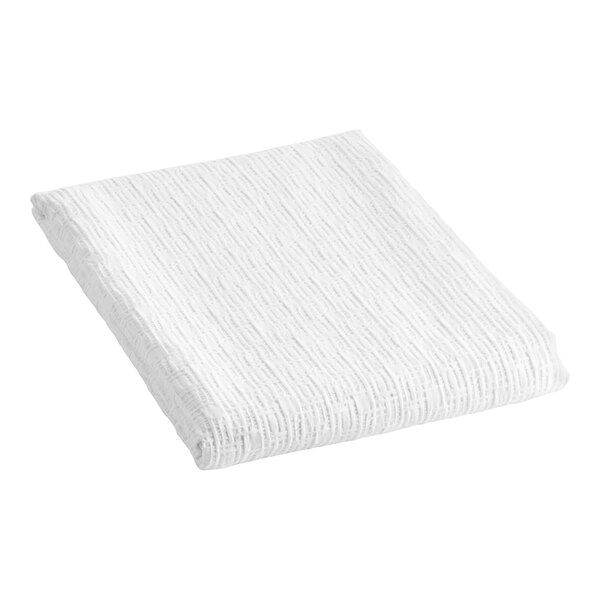 A white folded Berkshire Hospitality king size top sheet with a rattan pucker jacquard pattern.