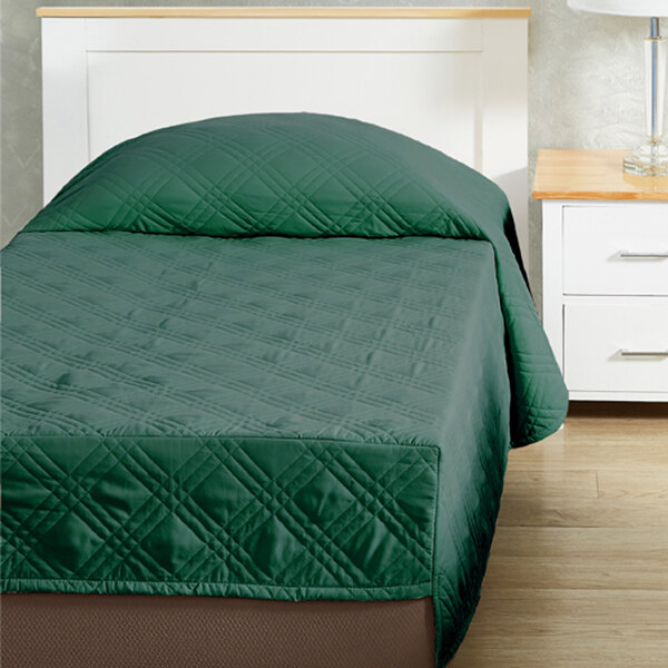 A green Berkshire Hospitality CozyCare Classic fitted coverlet on a bed.