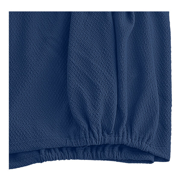 A close-up of a blue fabric with a diamond pattern.