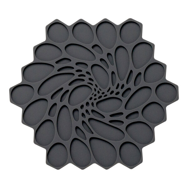A black hexagonal silicone trivet with circular designs.