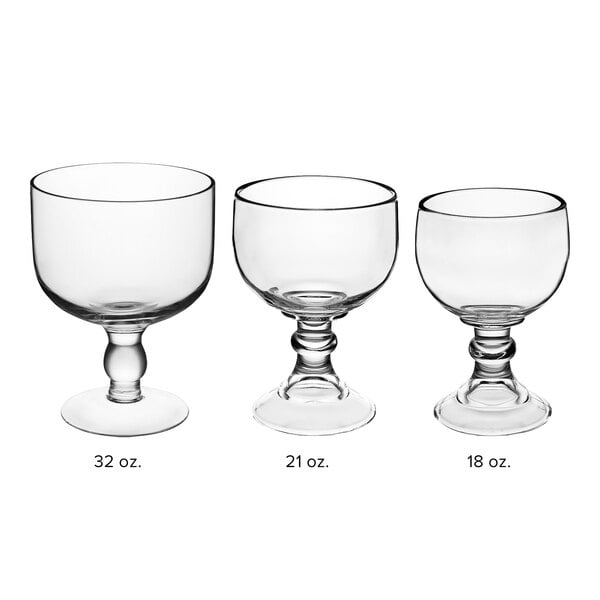 A row of clear Acopa Schooner glasses with stems and bases.