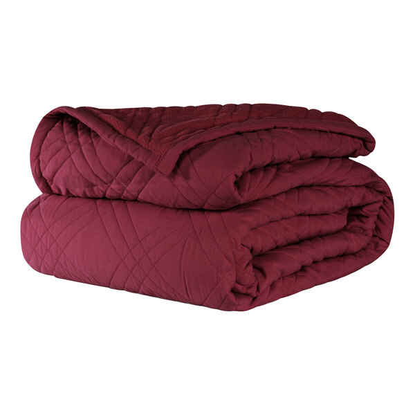 A stack of burgundy Berkshire Hospitality CozyCare Classic bedspreads.