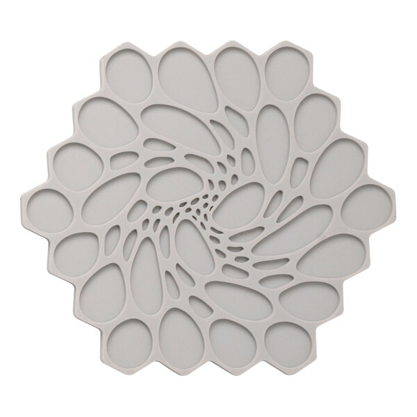 A white hexagonal silicone trivet with circular designs.