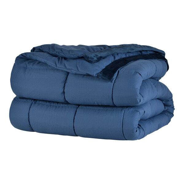 A stack of blue Berkshire Hospitality twin size blankets.