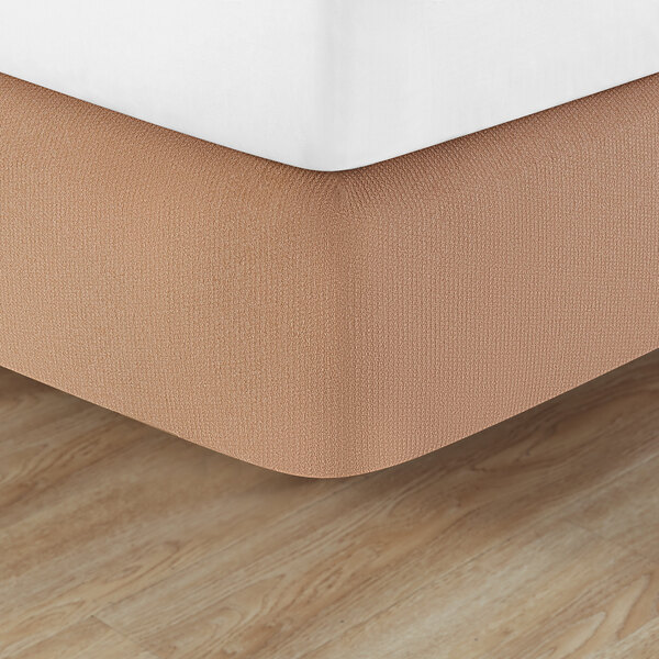 A close up of a bed with a Berkshire Hospitality Helix Box Spring Cover on it.