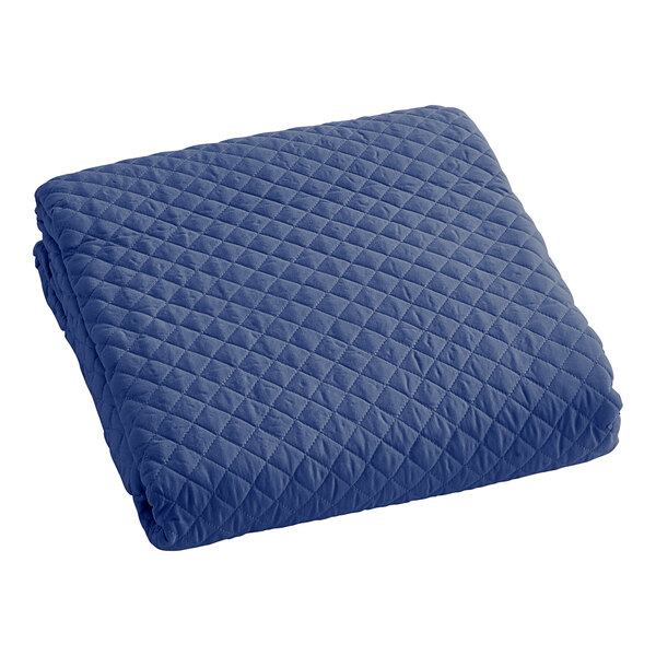 A blue quilted Berkshire Hospitality coverlet.