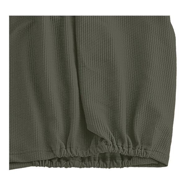 A close up of a green Berkshire Hospitality Helix Box Spring cover.