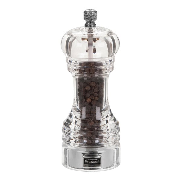 A Trudeau acrylic pepper mill with black peppercorns and a clear lid.