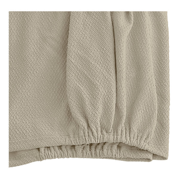 A close-up of a khaki Berkshire Hospitality knit2fit Diamond Box Spring Cover.