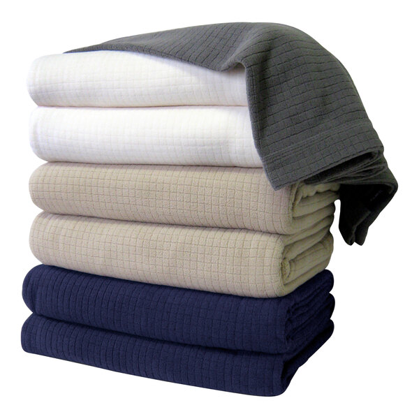 A stack of folded gray Berkshire Hospitality Polartec Softec fleece blankets.