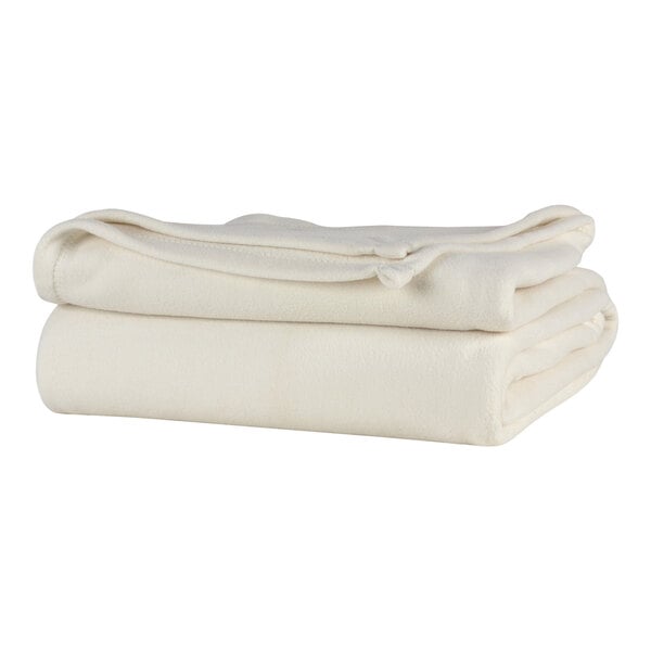 A stack of cream Berkshire Hospitality twin size blankets.