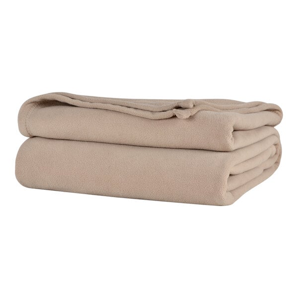 A stack of beige Berkshire Hospitality Microfleece blankets.