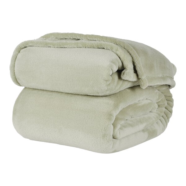 A stack of beige Berkshire Hospitality twin size blankets.
