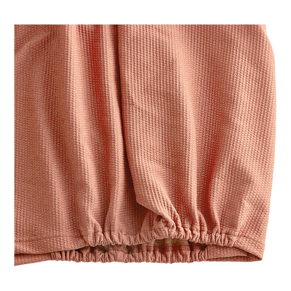 A Berkshire Hospitality paprika knit Helix box spring cover.