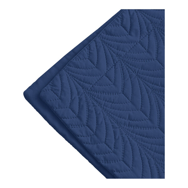 A white standard/queen size pillow sham with a blue quilted botanical leaf pattern.