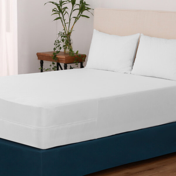 A white queen size bed with a Berkshire Hospitality Protextile white mattress encasement.