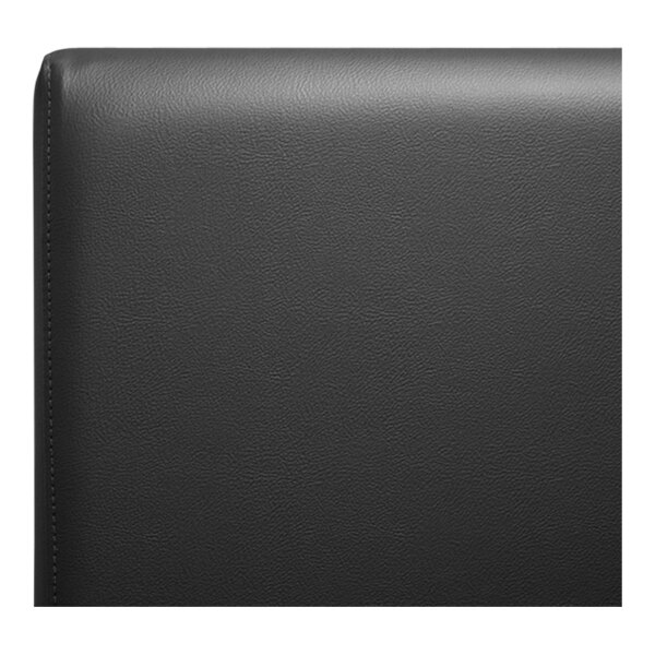 A close-up of a black leather surface on a QA Group black single back booth.