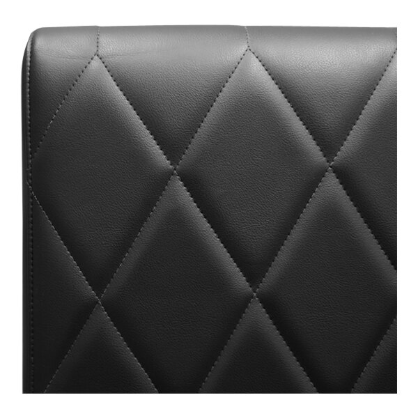 A black leather QA Group booth back with diamond tufting.