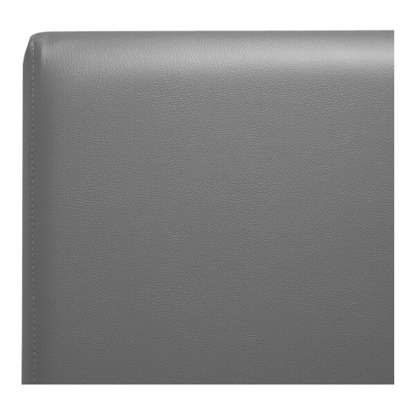 A close up of a graphite grey leather headboard on a QA Group booth.