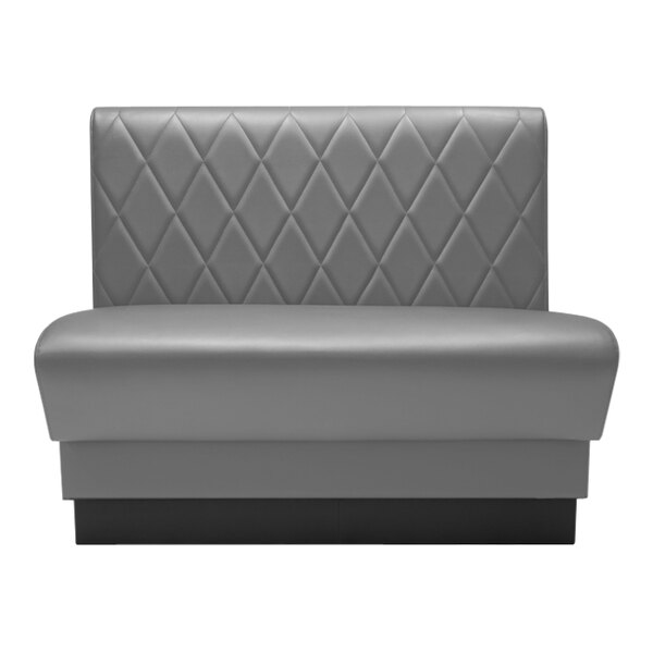 A grey leather booth with a black diamond tufted back.