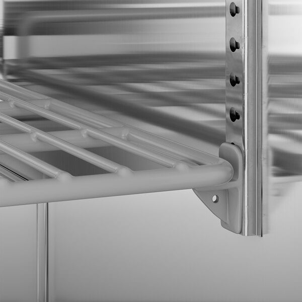 A stainless steel shelf with a metal rack in an Avantco undercounter freezer.