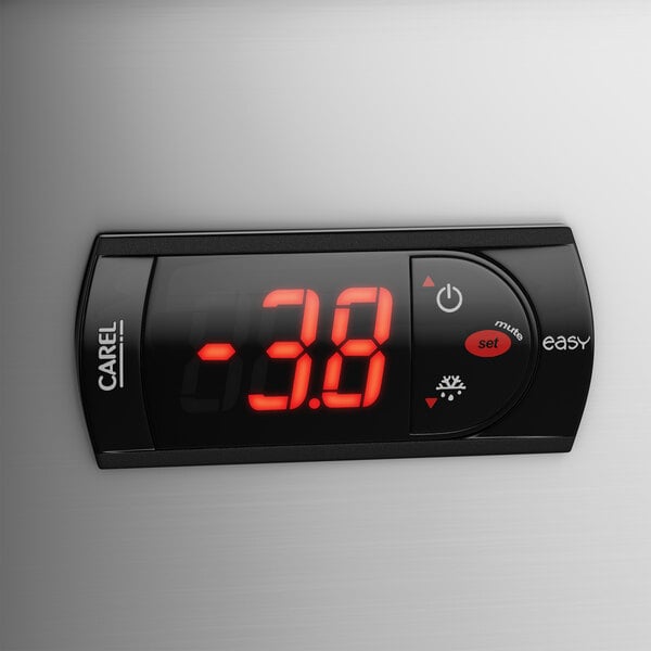 A digital thermostat on a white surface above a Avantco undercounter freezer.