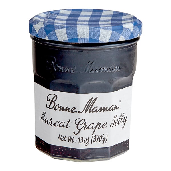 A Bonne Maman Muscat Grape Jelly jar with a blue and white checkered lid.