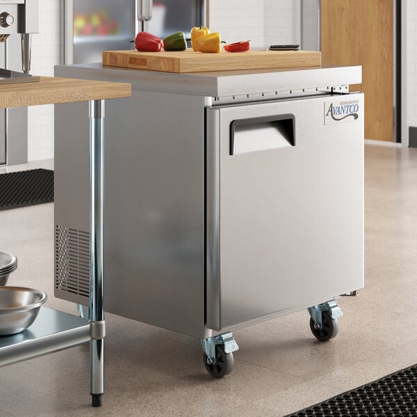 An Avantco stainless steel undercounter freezer with a cutting board on top.