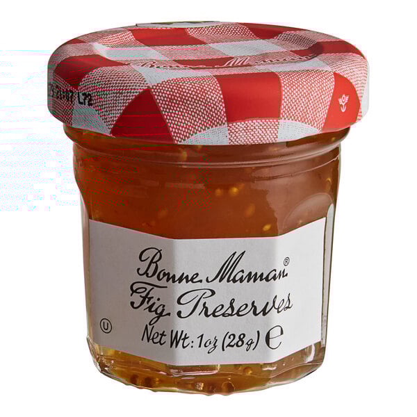 A Bonne Maman mini jar of fig preserves with a red and white checkered lid and white label.