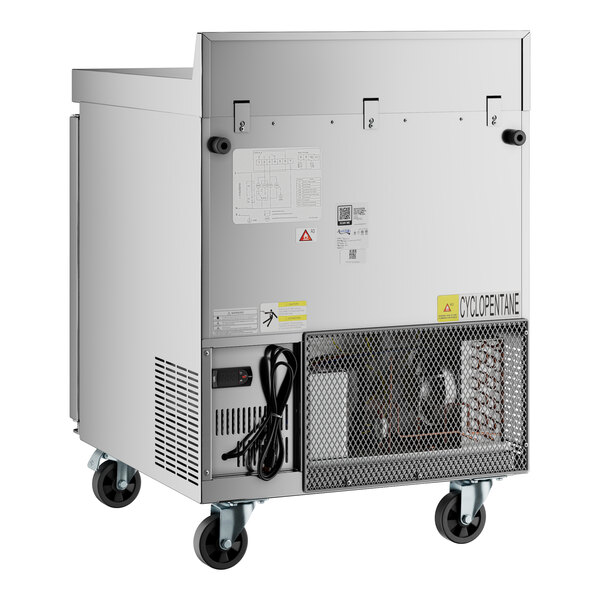 An Avantco silver worktop refrigerator with wheels.