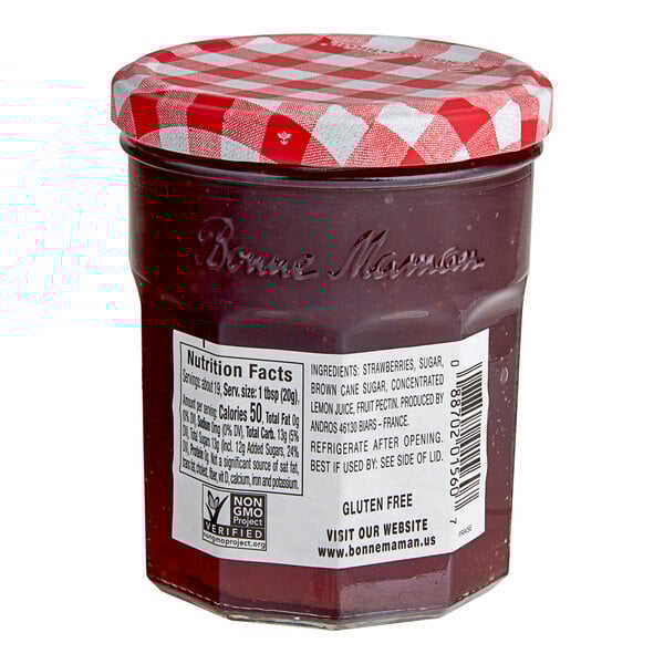 A Bonne Maman jar of strawberry preserves with a red and white checkered lid.
