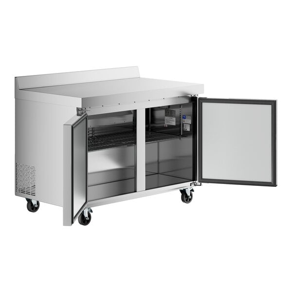 A stainless steel 48-inch worktop freezer with a 3 1/2-inch backsplash and two open doors revealing interior shelving.