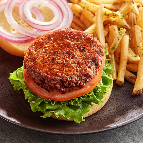 A Hungry Planet vegan beef burger with lettuce and tomato on a plate.