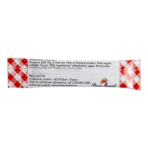 A close-up of a Bonne Maman Strawberry Preserves stick packet with a red and white checkered label.