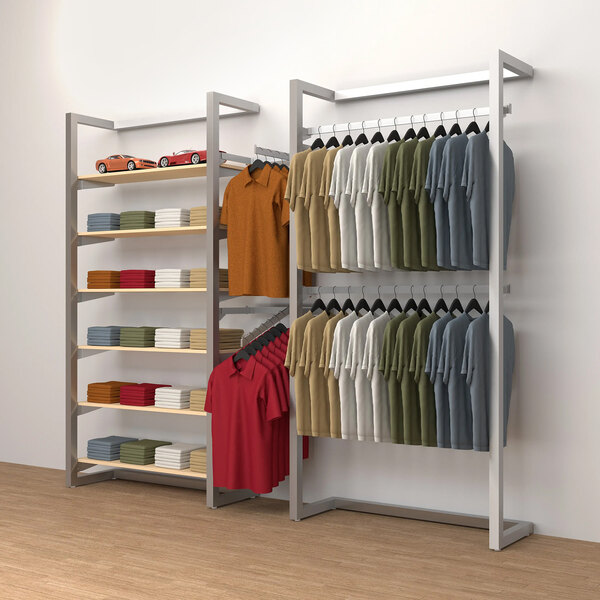 A white wall-mounted retail display with clothes hanging on it.